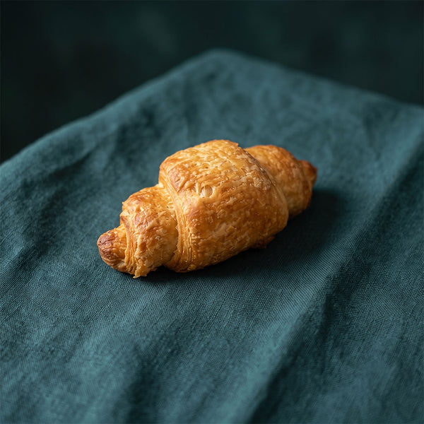 Kicsi méretű, réteges, aranysárga leveles croissant.